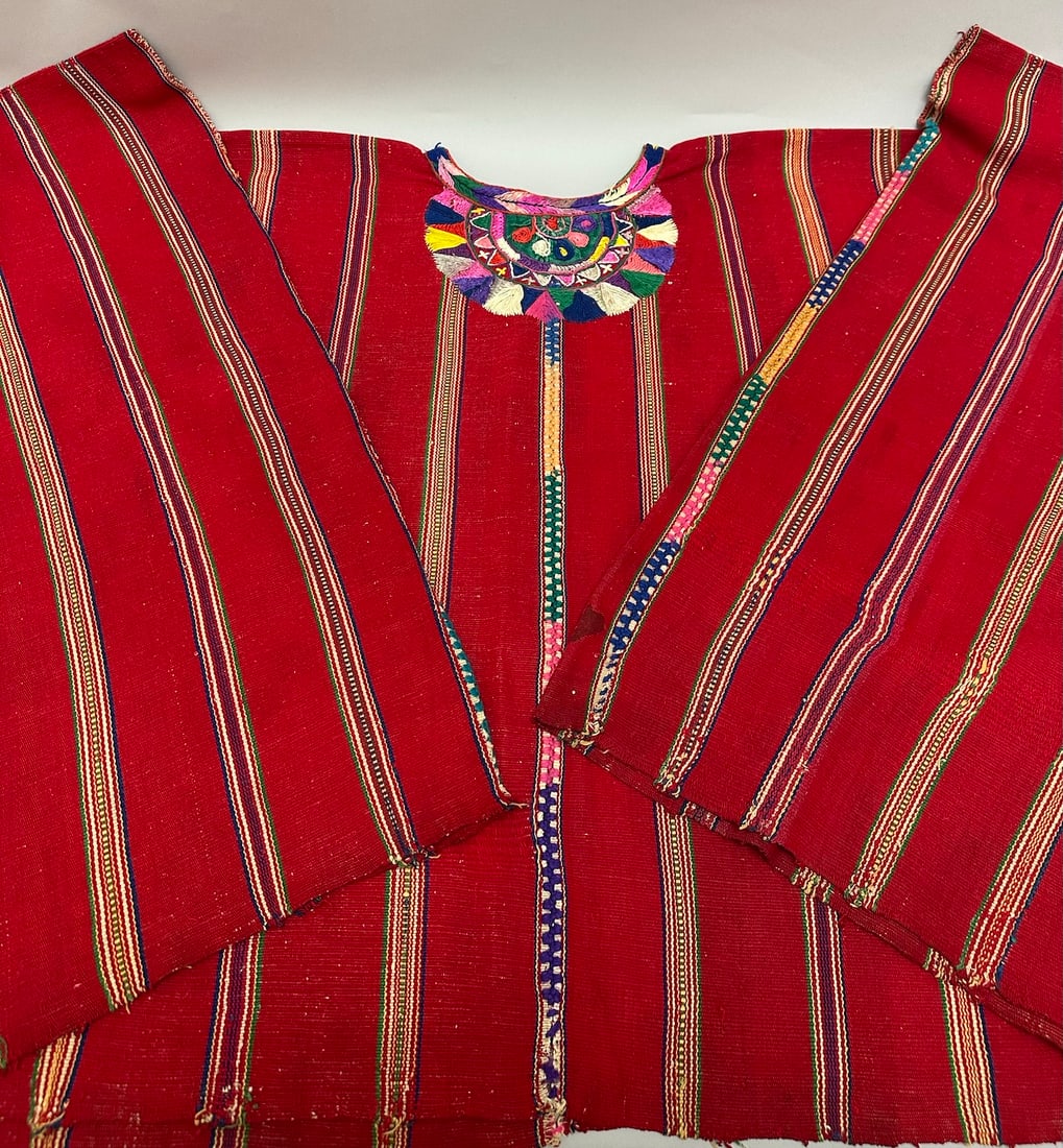 Traditional Handwoven Guatemalan Vest: Traditional handwoven vest with Guatemalan folk art. A cotton fabric in red base with thin stripes. Embroidery around neckline. D: 51" W x 25"L.