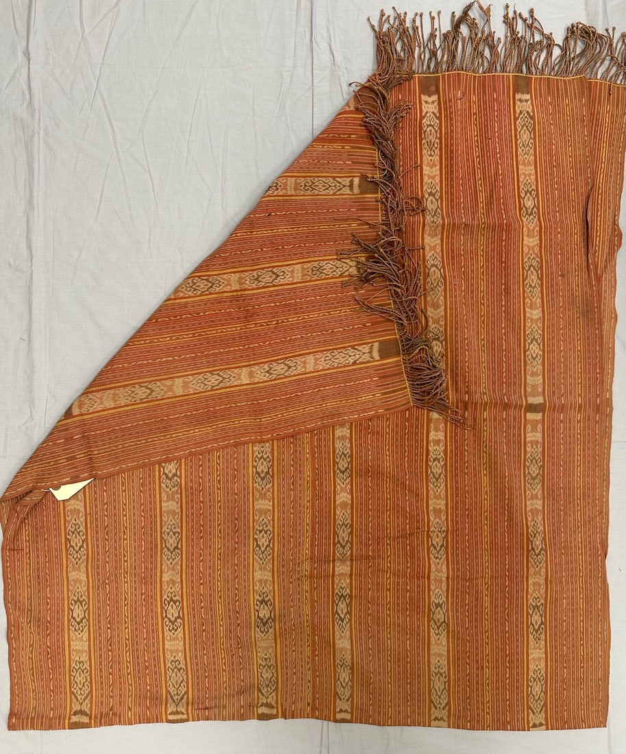 Handwoven Cotton Ikat Timor Bresoli Blanket: Handwoven cotton ikat Timor Bresoli blanket from Indonesia from early 20th. with fringes. Traditional motifs in colors orange, yellow, brown. D: 37" x 82".