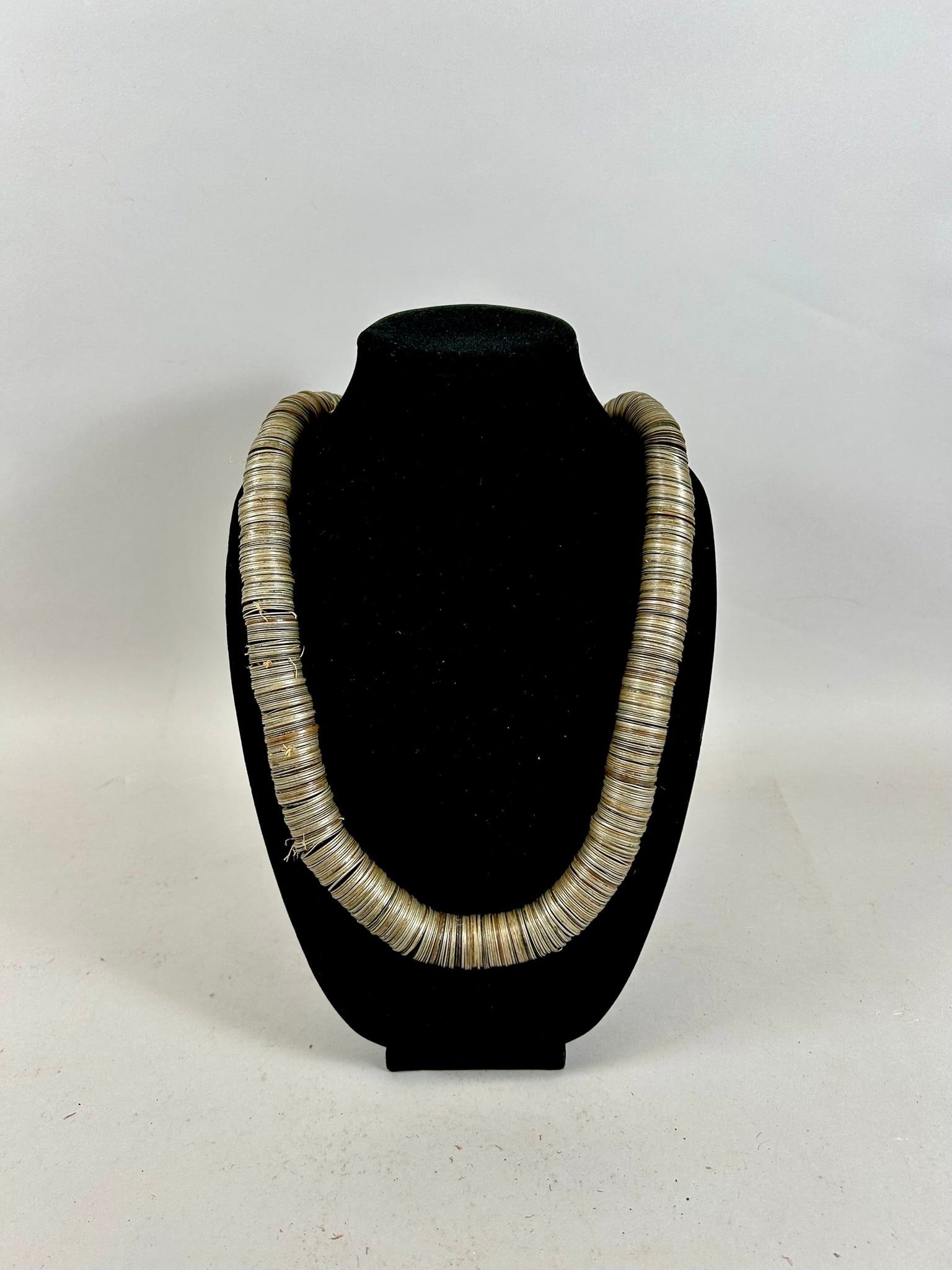 British West African Coin Necklace: A large collection of coins, appears to be principally British West African one-tenth penny currency from the 1930's and 1940's, assembled as a necklace. Total number of coins appears to be 500+, West