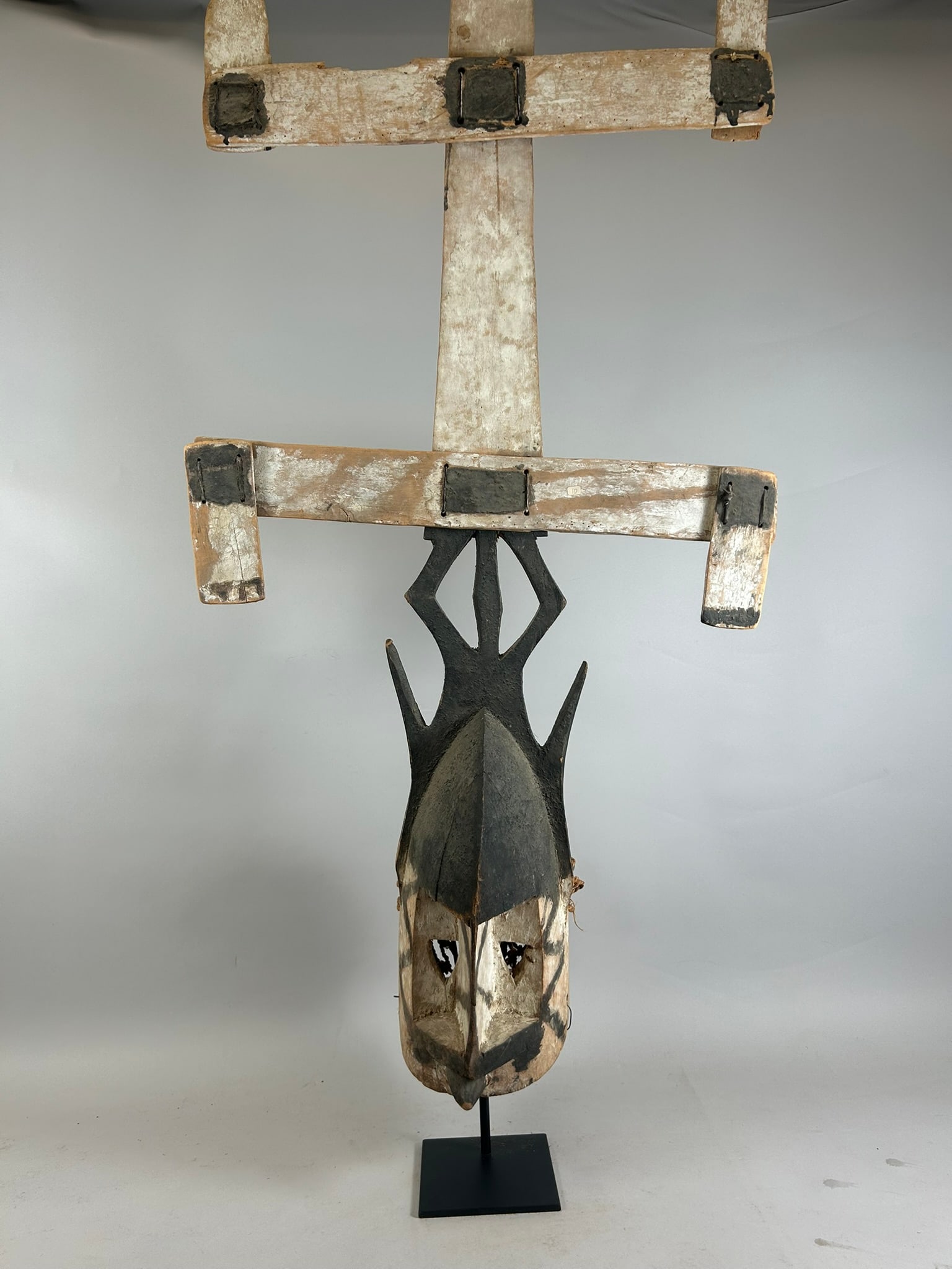 Dogon Kanaga Mask: A carved wood Kanaga mask, with leather, pigments, and fiber, Dogon peoples, Mali, West Africa. Stand is not included. Approximate dimensions: 42.5" x 21.5" x 7"