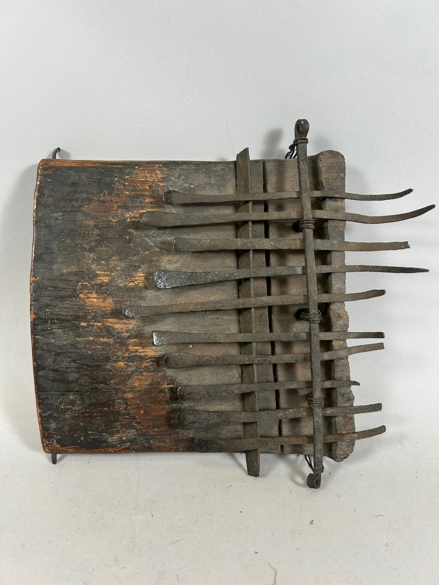 Congolese Sanza (Thumb Piano): A sanza, or thumb piano, carved wood and metal, 10 keys, Democratic Republic of the Congo, Central Africa. Approximate dimensions: 9" x 8" x 1.25"