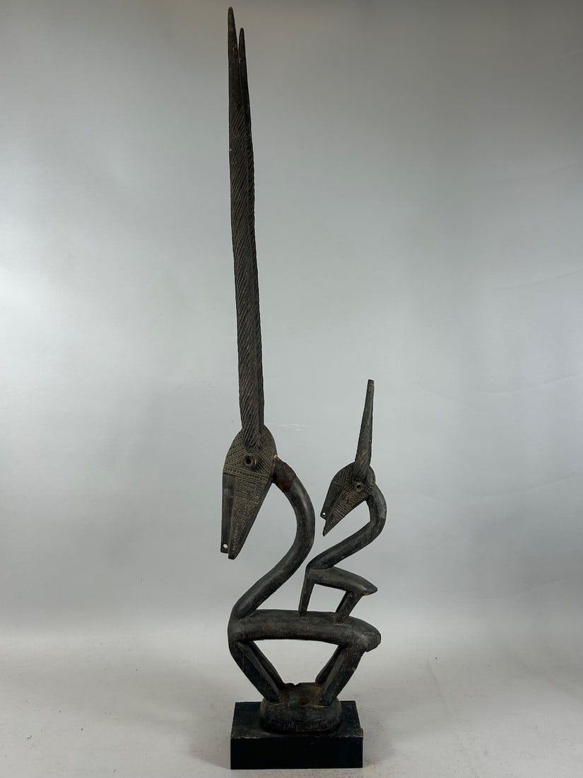 Chiwara Headdress, Mali: A carved wood headdress, chiwara or chiwara style, on wood base, Bamana peoples, Mali, West Africa. Approximate dimensions: 38" high (39.5" on base)