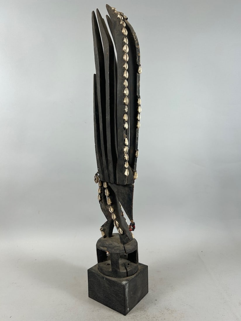 Chiwara Headdress, Mali: A carved wood headdress, chiwara or chiwara style, cowries, on wood base, Bamana peoples, Mali, West Africa. Approximate dimensions: 23" high (26" on base)