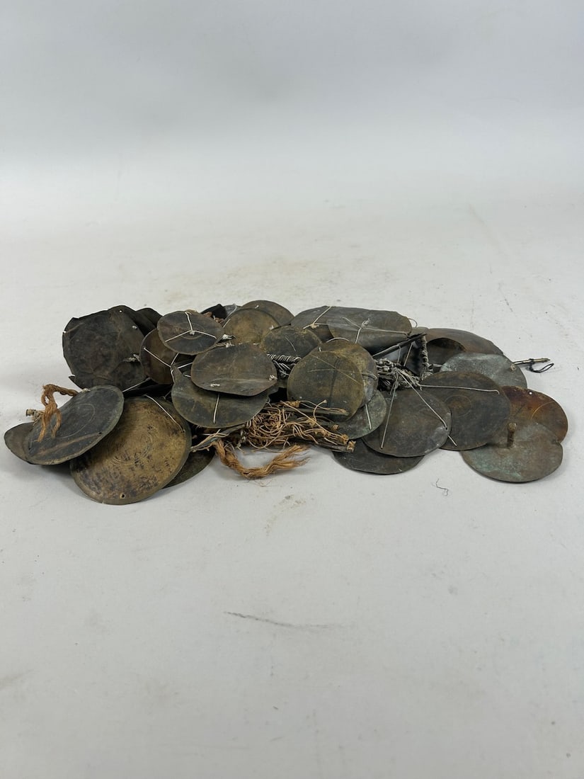 Akan Brass Scales: A heavily tangled collection of pressed brass weighing pans with pressed brass beams and threads, Akan peoples, Ghana, West Africa. Approximate dimensions: Most pans around 2", beams around 4.5" - 5"