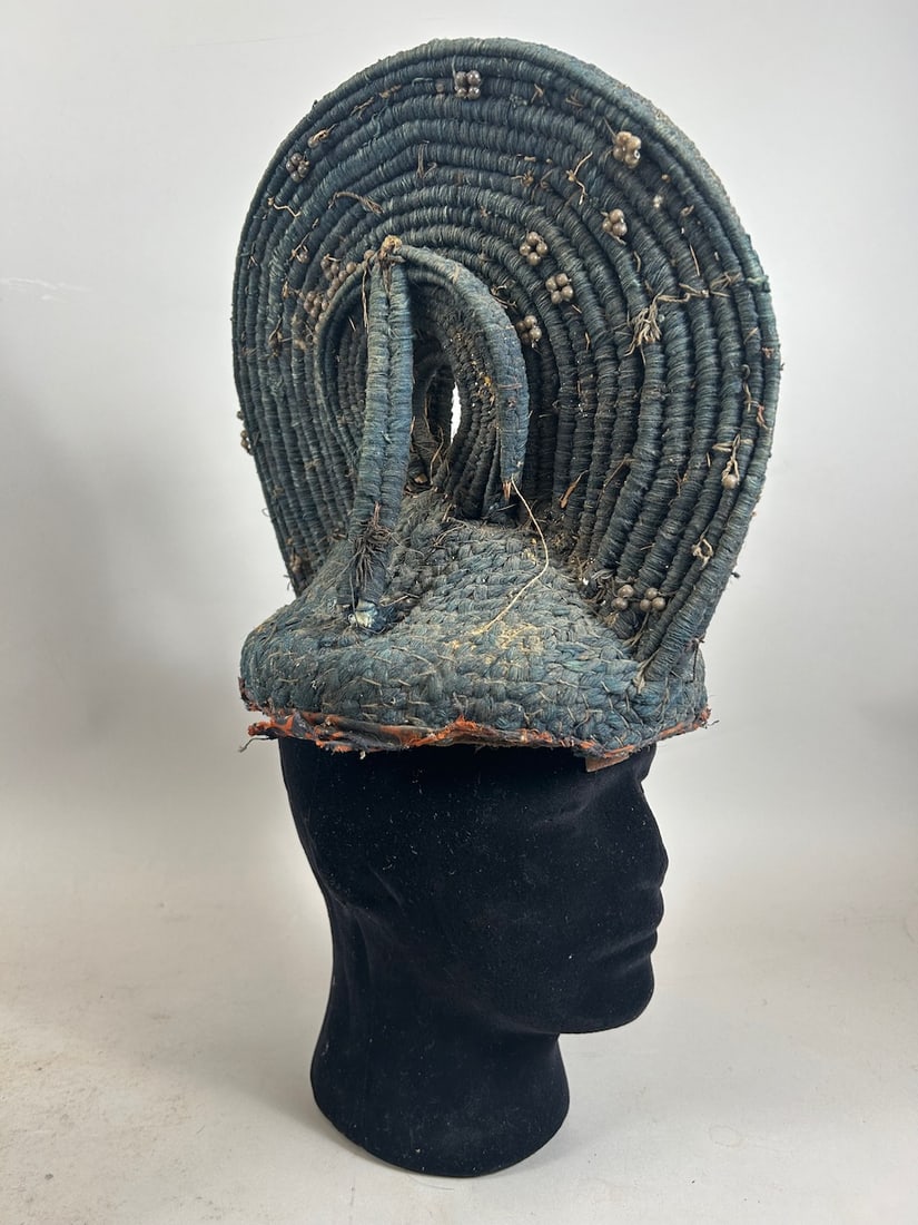 Egungun Headdress: A woven fiber headdress, possibly Egungun, with attached metal beads, and loss of textile to cover face, Nigeria, West Africa. Stand is not included. Approximate dimensions: 11" x 11" x 7.5"