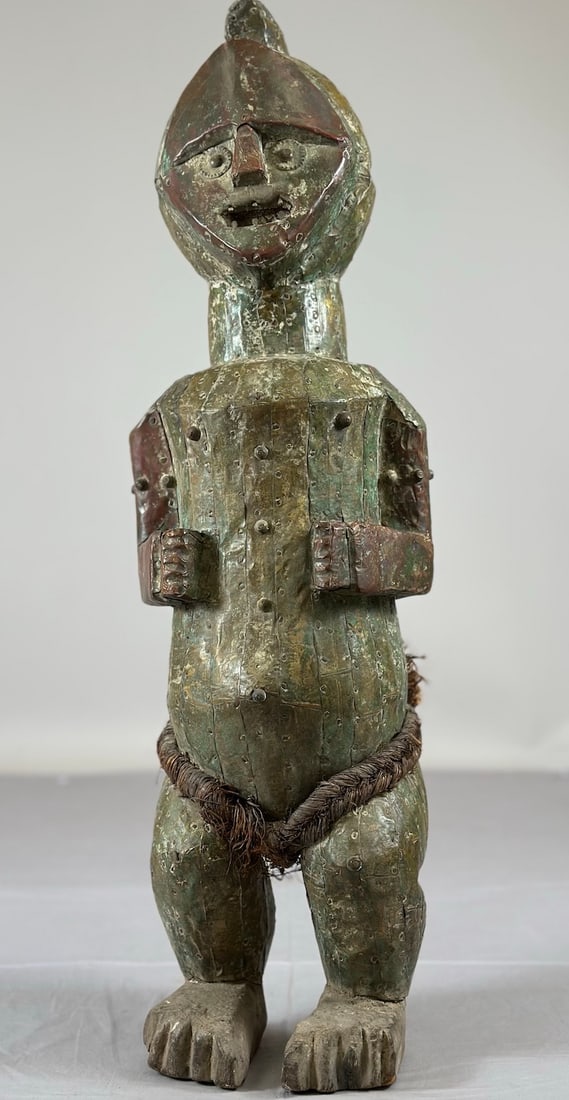 Ambete Fetish, Metal Covered: A heavy carved wood and metal-covered Ambete style fetish figure, Republic of Gabon, Central Africa. Approx. 25" x 8" x 7"