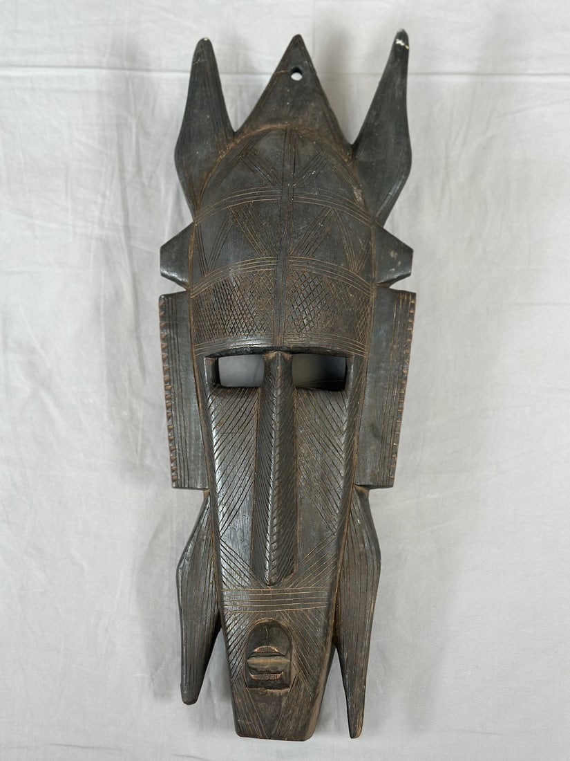 Senufo Kpeliye Mask: A carved wood Kpeliye style mask, Senufo peoples, Ivory Coast, West Africa. Approx. 17" x 6" x 4"