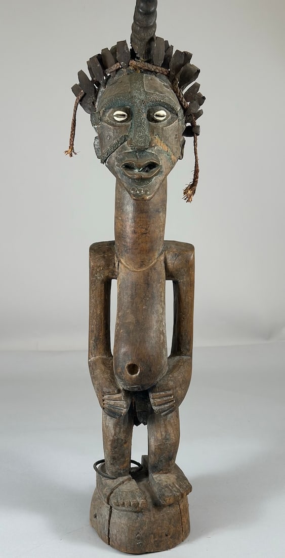 Songye Nikisi Power Figure: A carved wood, metal, horn and fiber nkisi power fetish, Songye peoples, Democratic Republic of the Congo, Central Africa. Approx. 31" x 7" x 7"