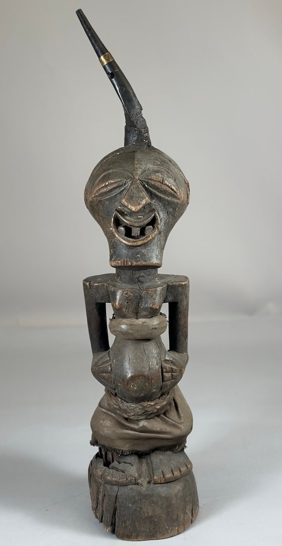 Songye Nikisi Power Figure: A carved wood, horn,metal, textile and fiber nkisi power fetish, Songye peoples, Democratic Republic of the Congo, Central Africa. Approx. 23" x 7" x 7"