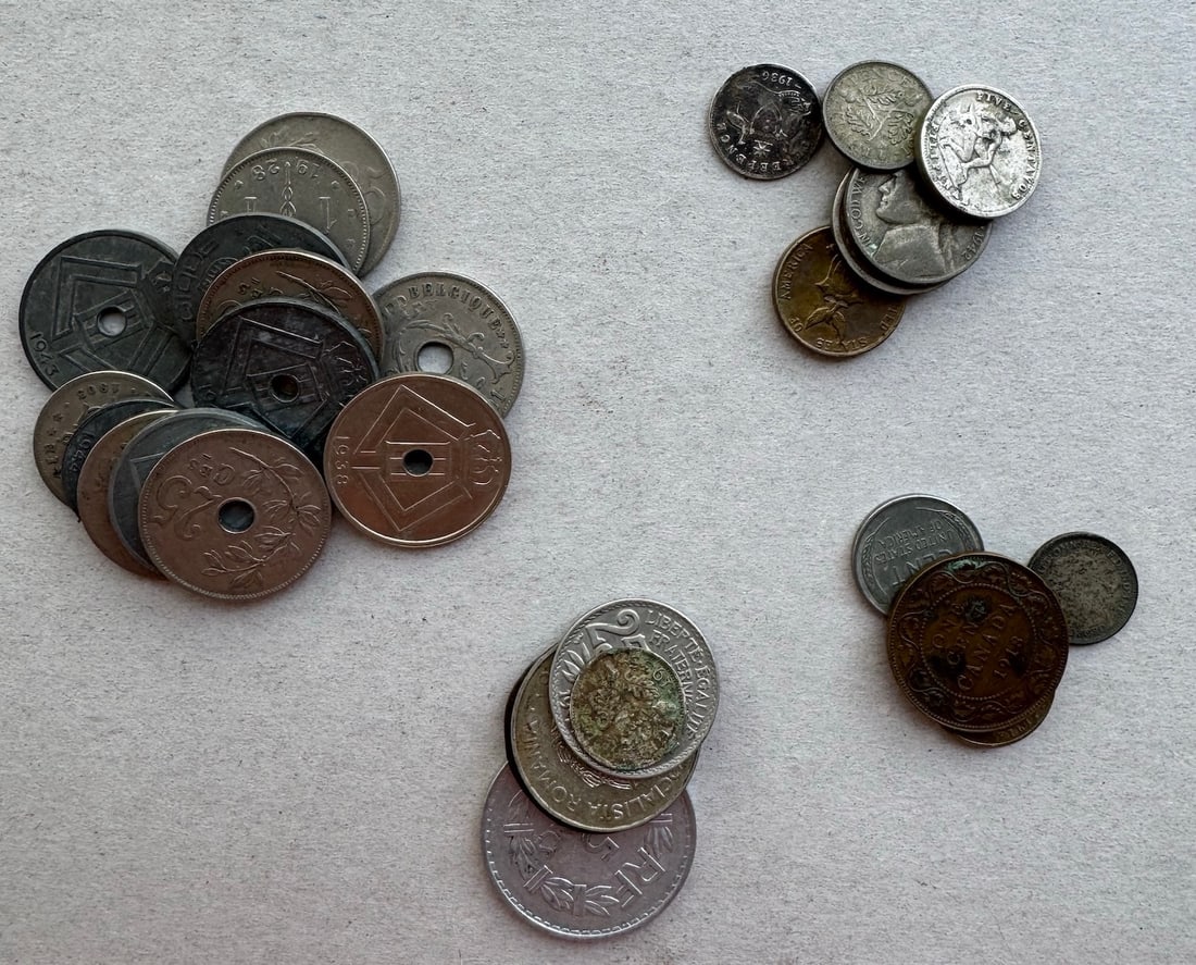 US and World Coins from Belgium, France, Canada, Phillippines, Brazil, British, Australia and: 12 Belgium Centimes coin, issued during and after World War II; French Centimes coin; Canadian coin; Centavos coin from the Phillippines under US administration; US coins; Brazillian Reis coin; Britis