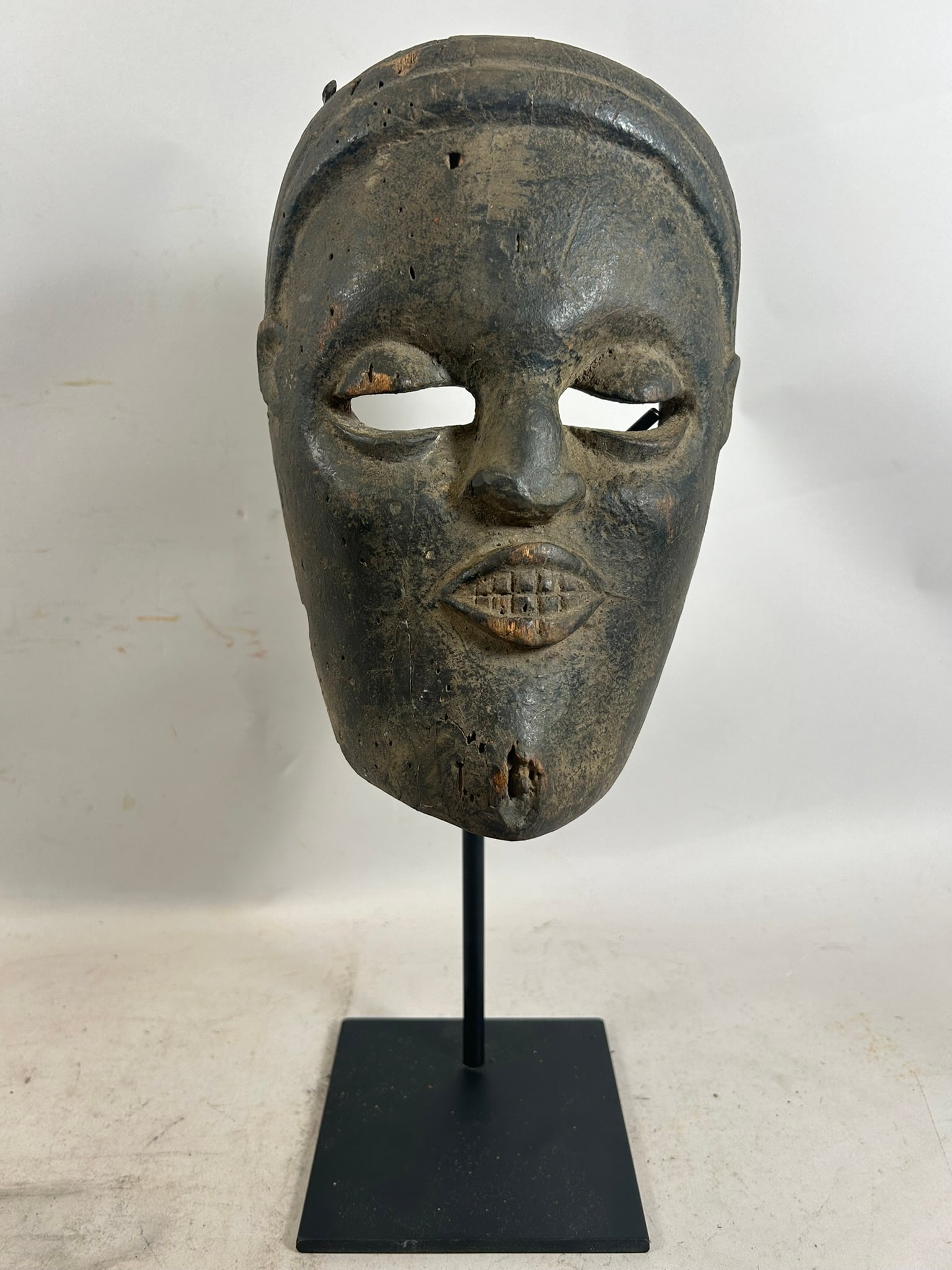 African Wooden Carved Mask: African Wooden Carved Mask. 10"h x 7"w x 3.5"l (stand not included)