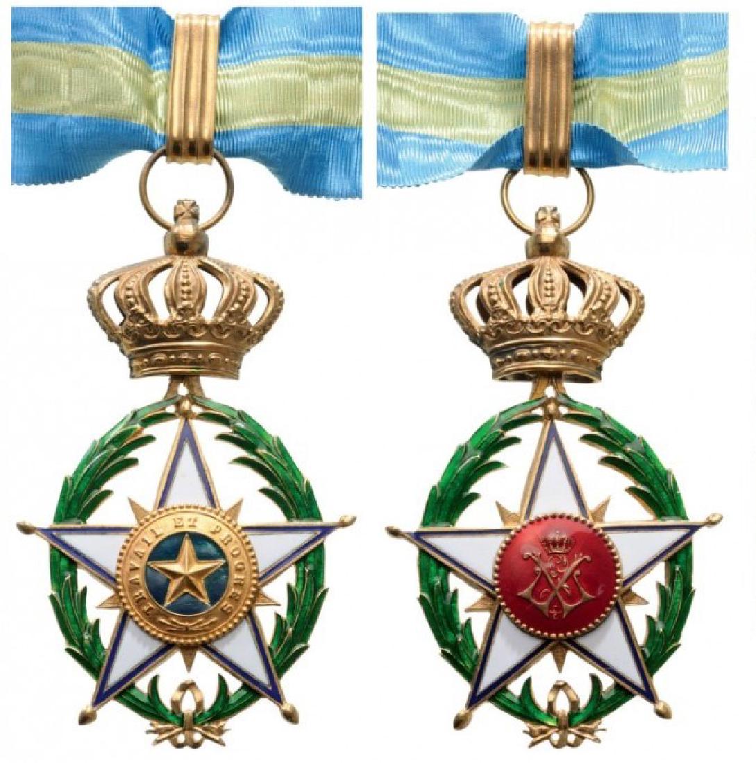 ORDER OF THE AFRICAN STAR: Commander's Cross, 1st Type, 3rd Class, instituted in 1888. Neck Badge, 61x57 mm, gilt Bronze, enameled, both central medallions gilt bronze, enameled, original suspension loop and long neck ribbon. R