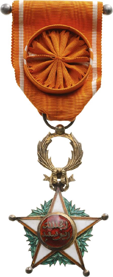 ORDER OF THE OUISSAM ALAOUITE: Officer's Cross, 4th Class, instituted in 1913. Breast Badge, 64x42 mm, gilt Silver, both sides enameled, multipart construction, original suspension wreath, ring and ribbon with rosette. II