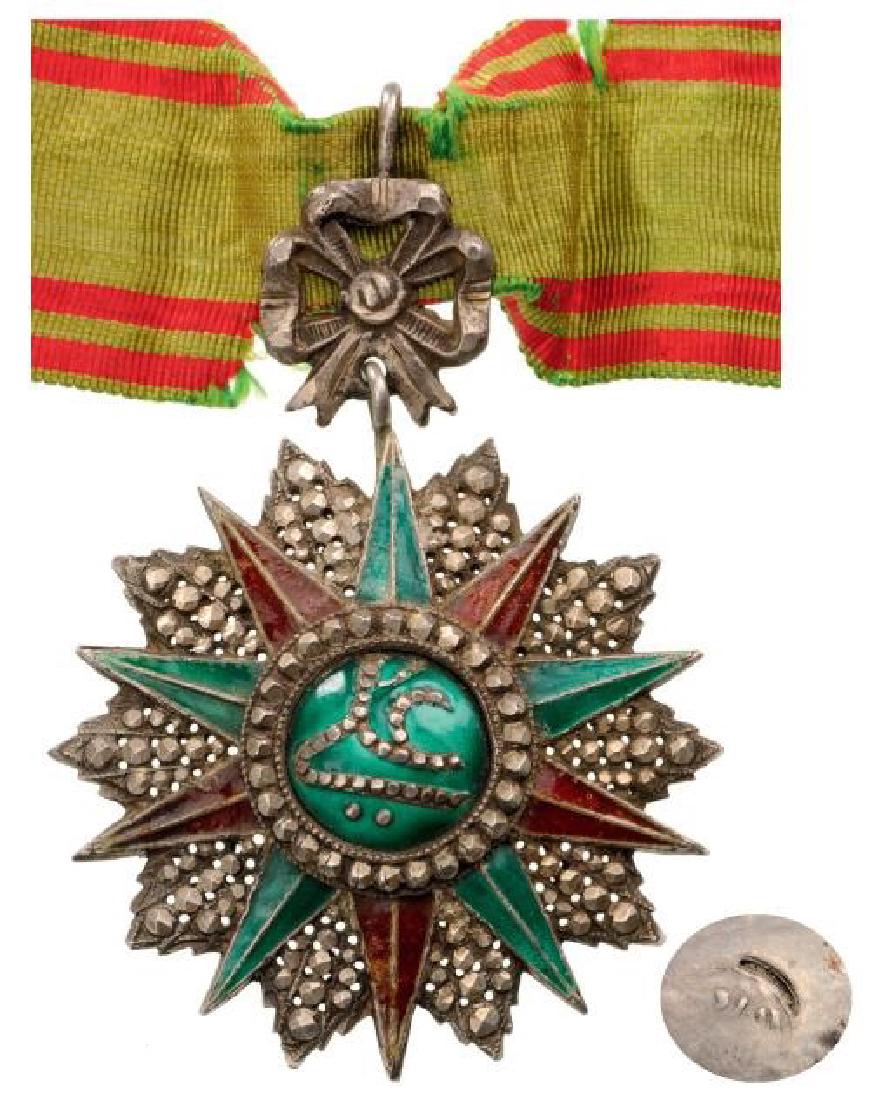 ORDER OF NICHAN AL IFTIKHARÂ : Commanderâ€™s Cross, 3rd Class, Ali Bey Period (1882 - 1902). Neck Badge, silver with brilliant cut rays, 62 mm, partially re pierced, enameled, central medallion silver, enameled, original ornam