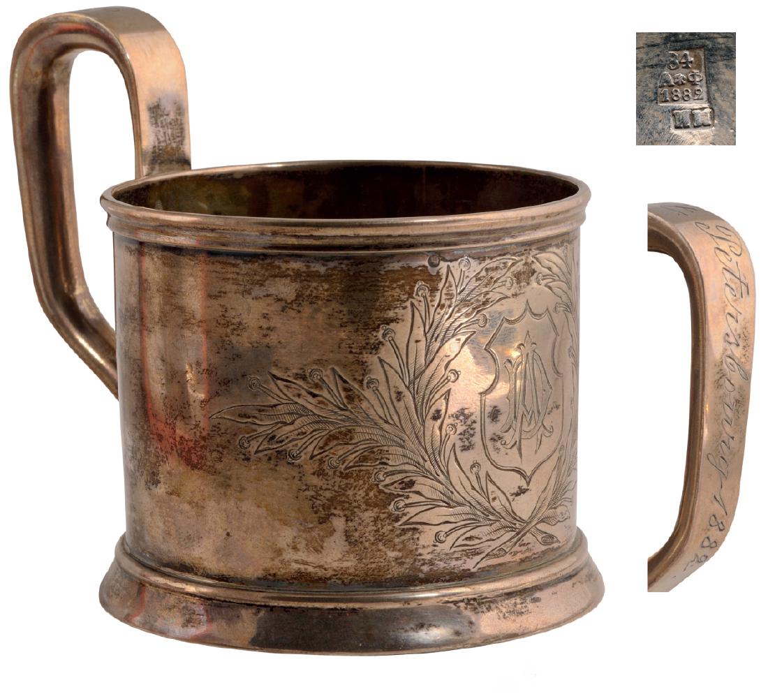 Gilded silver tea glass holder (podstakannik): Circular body and base, fl oral pattern, initials "AD" in reserve, height 9 cm, weight 120 g, "84" standard guarantee, St. Petersburg 1882, silversmith Ilya Mineev, assayer`s mark "AF". 3718