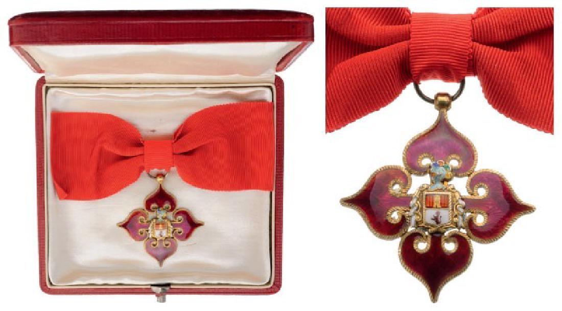 ORDER OF THE ROYAL CORPS OF KNIGHTS OF MADRID'S: Nobility Dames' Cross. Breast Badge, chiseled and enameled gilt Silver, superimposed by the finely enameled coat of arms of "Castilla and Leon", original red silk ladies' bow and red leather case of i