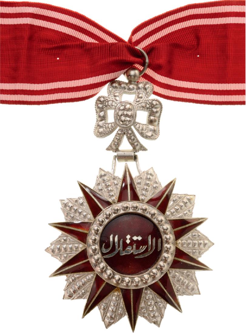 ORDER OF NICHAN AL IFTIKHARÂ : Commander's Cross, 2nd Type. Neck Badge, silver, superimposed central medallion, enameled, original suspension ring and ribbon. Extremely fi ne and beautiful! I