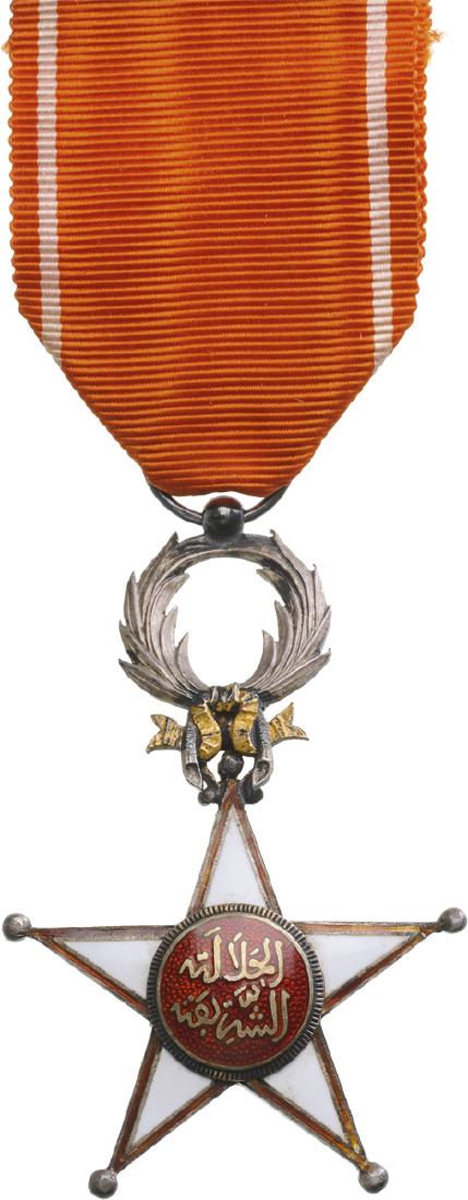 ORDER OF THE OUISSAM ALAOUITE: Knight`s Cross, 5th Class, instituted in 1913. Breast Badge, gilt Silver, 63x42 mm, both sides enameled, both central medallions gilt silver, enamel, original suspension ring and ribbon. I