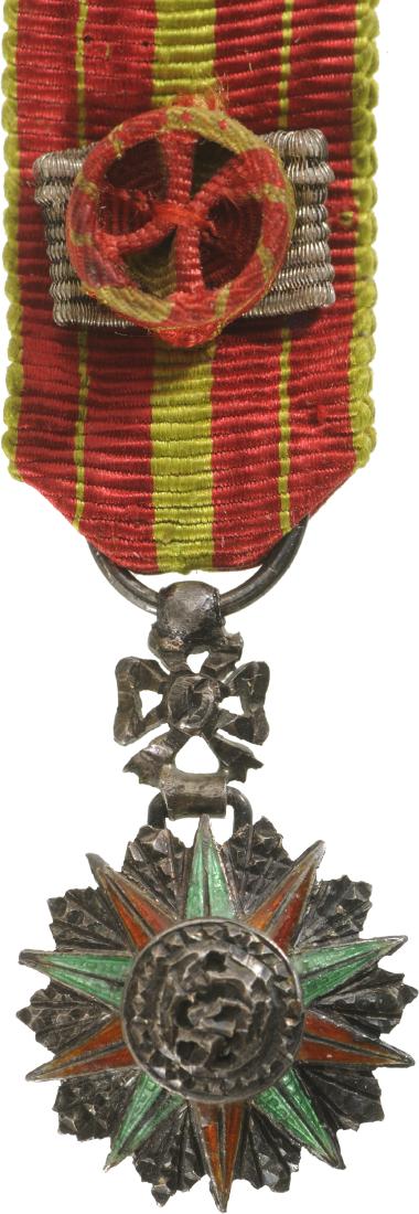 ORDER OF NICHAN AL IFTIKHAR: Commander's Cross Miniature, 3rd Class. Breast Badge, 22x14 mm, Silver with brilliant cut rays, central medallion silver, enameled, original ornamented suspension device and ribbon with rosette and si