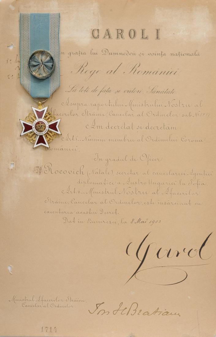 ORDER OF THE CROWN OF ROMANIA, to a Secretary of the: Officer 's Cross, 1st Model, Civil. Breast Badge, 38 mm, Bronze gilt, both sides enameled, original ring and ribbon with rosette, together with awarding document, 312x202 mm, dated 8.05.1903, original