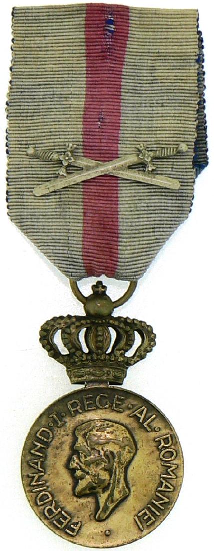 Medal of Ferdinand I, instituted on 10th of May 1929 by: ROMANIA, Breast Badge, 31 mm, Bronze, on obverse King Ferdinand I, "small head", on reverse the dates of reign "1914-1927", original ring and faded ribbon with swords. II