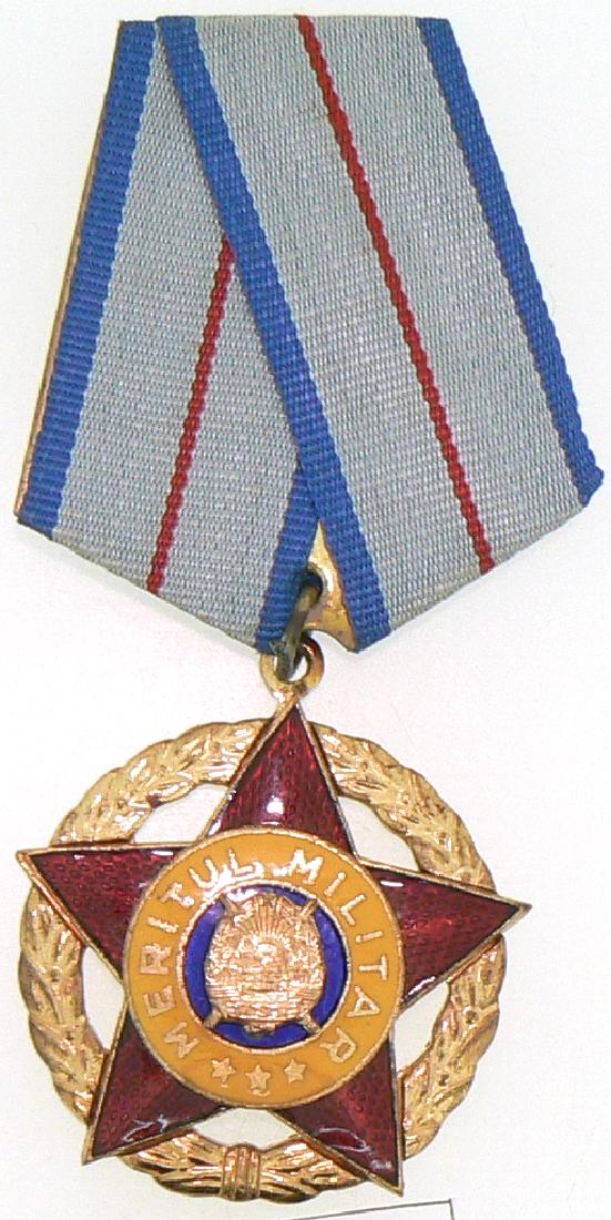 RSR - ORDER OF MILITARY MERIT, instituted in 1954: ROMANIA - SOCIALIST REPUBLIC, 1966-1989, 2nd Model, 1st Class (1966-1989). Breast Badge, gilt Bronze, 39 mm, center enameled, original suspension ring and ribbon in original plastic envelope. I