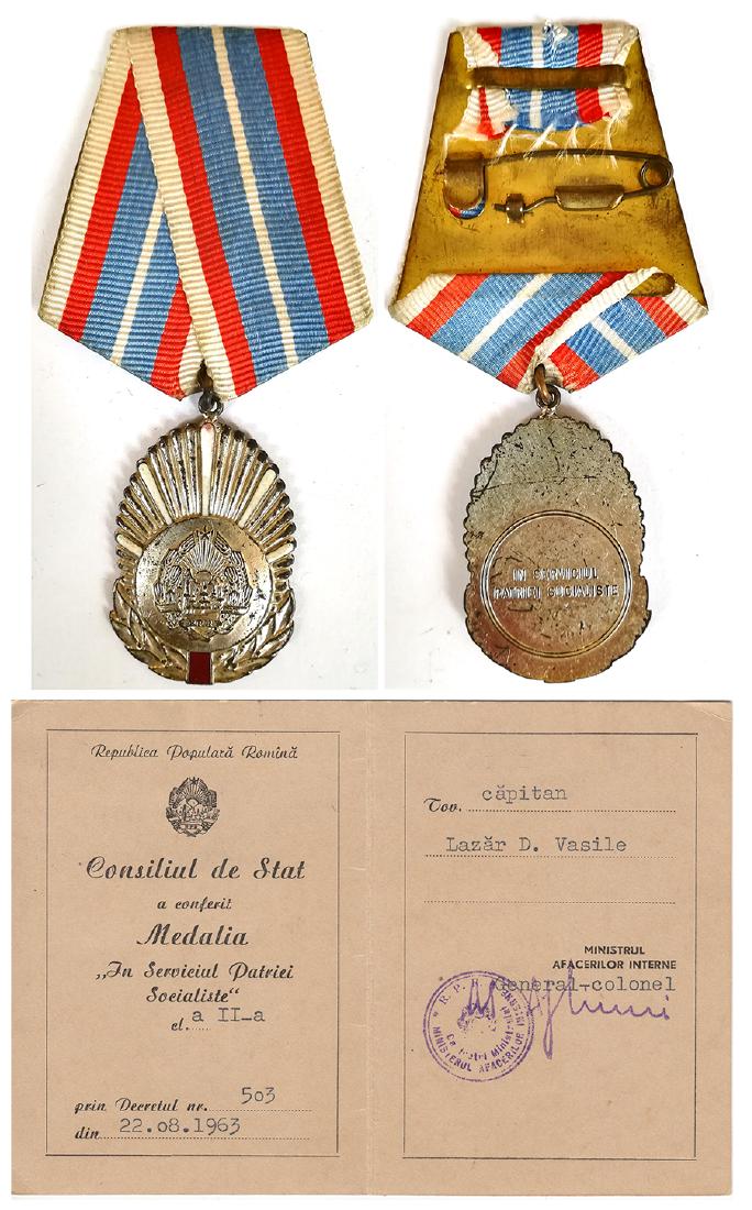RPR - MEDAL "IN SERVICE OF THE FATHERLAND", instituted: ROMANIA - POPULAR REPUBLIC, 1948-1965, 2nd Class. Breast Badge, 46x31 mm, silvered Bronze, original suspension ring and ribbon, together with awarding document, dated 22.08.1963. Rare! (2) I R!