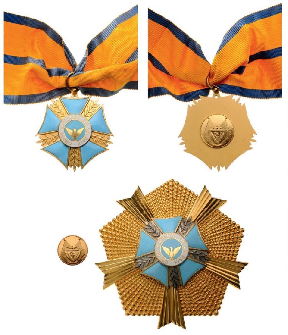 NATIONAL ORDER OF PEACE: RWANDA, Grand Officer's Set, 2nd Class. Neck Badge, 50 mm, gilt Bronze, one side enameled, central medallion enameled, original suspension ring and ribbon. Breast Star, 98 mm, gilt Bronze, maker's mar