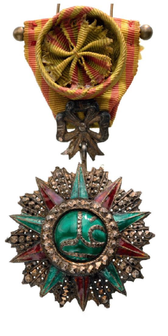 ORDER OF NISHAN EL IFTIKHAR: TUNISIA, Officer`s Cross, 4th Class, Ali Bey (1882‚ÄövÑv¨1902). Breast Badge, 67x47 mm, silver, partially enameled, Tunisian manufacture, original ribbon with rosette. Some minor damages in the 