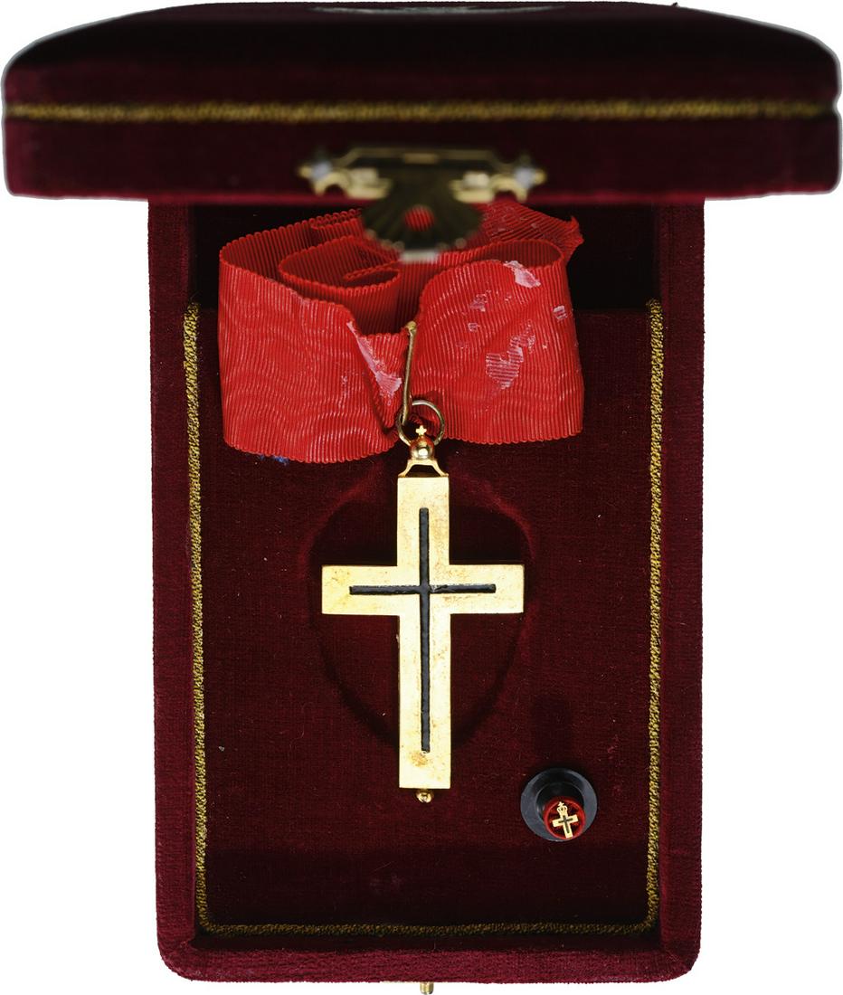 ORDER OF THE ORTHODOX PATRIARCHATE OF JERUSALEM: Commander`s Cross. Neck Badge, in gilt Bronze, 81x41 mm, black enameled cross, the cross can be opened, original red ribbon, in original velvet case of issue with gold weapon on the lid, and lapel hol