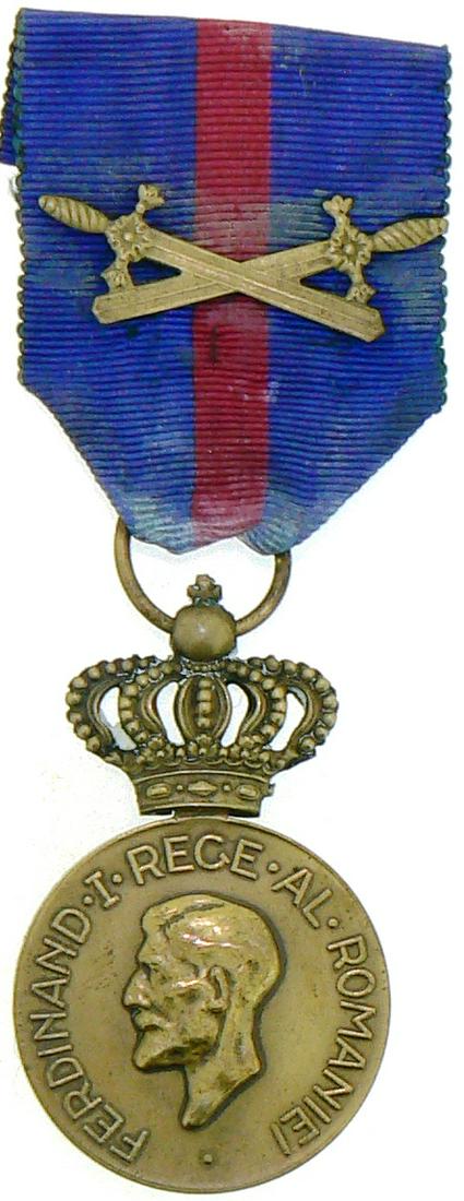 Medal of Ferdinand I, instituted on 10th of May 1929 by: Breast Badge, 31 mm, Bronze, on obverse King Ferdinand I, "small head", on reverse the dates of reign "1914-1927", original ring and ribbon with swords. I Country: ROMANIA