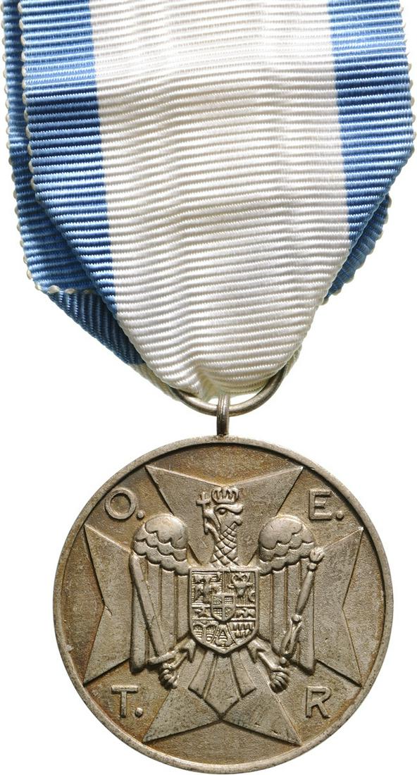 HOME GUARD MEDAL, instituted in 1934: 2nd Class Breast Badge, 35 mm, Bronze silvered, original suspension ring and ribbon. Rare! I ROMANIA