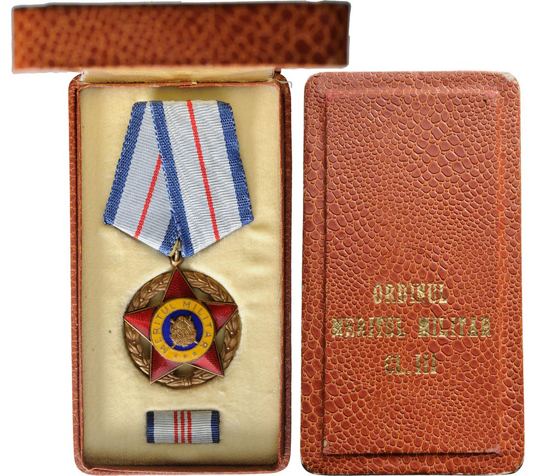 RPR - ORDER OF MILITARY MERIT, instituted in 1954: 1st Model, 3rd Class (1954-1965). Breast Badge, Bronze, 39 mm, center enameled, original suspension ring and ribbon, with ribbon bar, in original case of issue. I ROMANIA - POPULAR REPUBLIC, 1948-1965