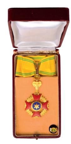 NATIONAL ORDER: Commander`s Cross. Neck Badge, gilt bronze, 45 mm, enameled, maker`s mark "A.B&Cie", both central medallions enameled, original ribbon. In original case of issue by "ARTHUS BERTRAND, PARIS" with roset