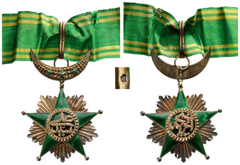 ORDER OF THE STAR OF COMOROS: Commander's Cross, 3rd Class, 2nd Type, instituted in 1910. Neck Badge, 80x60 mm, gilt Silver, French hallmarked, maker's mark "Arthus Bertrand, Paris", both sides enameled (some damages), central med