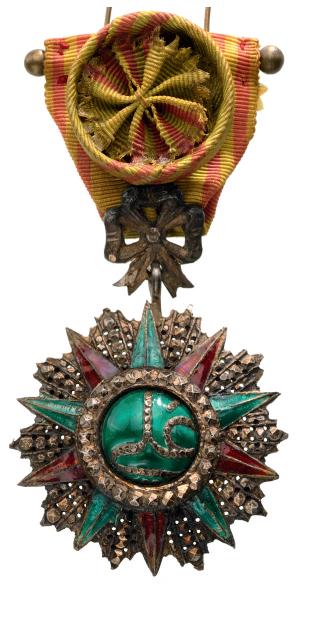 ORDER OF NICHAN AL IFTIKHAR: Officer`s Cross, 4th Class, Ali Bey (1882-1902). Breast Badge, 67x47 mm, silver, partially enameled, Tunisian manufacture, original ribbon with rosette. Some minor damages in the enamel. II