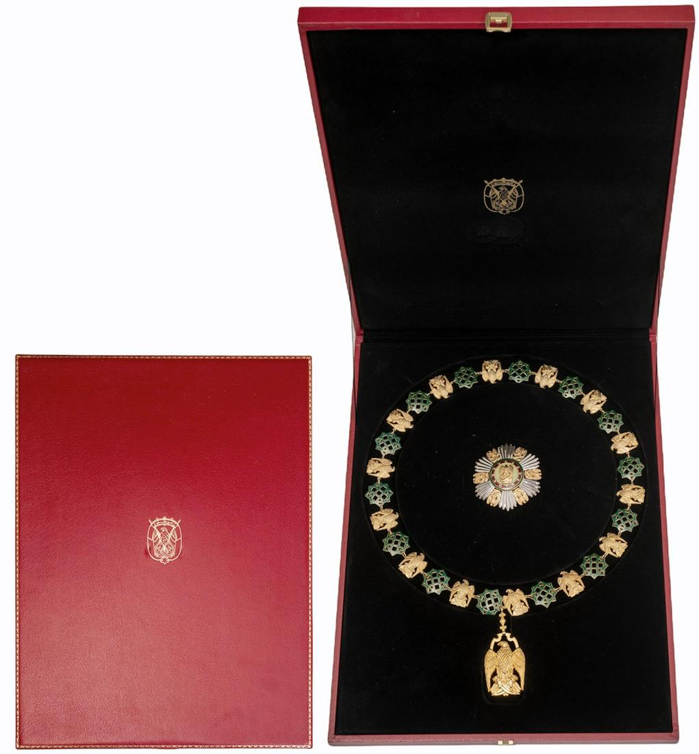 The Al-Nayyan Royal Family Order: A full set of insignia of the Order: gilt silver collar composed of 14 eagles and 14, green enameled geometric ornaments, all kept together by tiny links, to which the Orderâ€™s badge is appended
