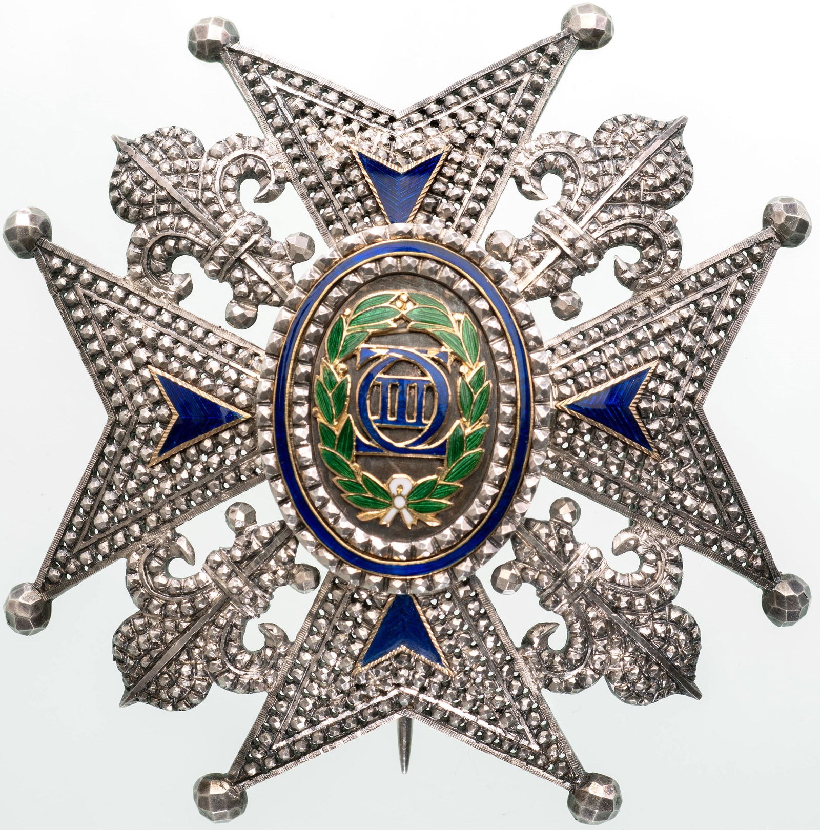 ORDER OF CHARLES III: Commander's Breast Star, 72 mm, with chiseled and pierced arms with blue enameled details, flanked by fleurs de lys; oval centre medallion with blue enameled royal cypher and green enameled laurel wre