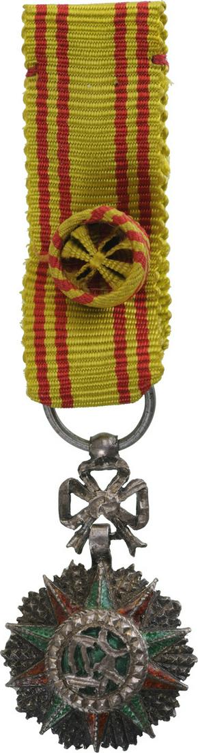 ORDER OF NICHAN AL IFTIKHAR: Officer's Cross Miniature, 4th Class. Breast Badge, 24x15 mm, Silver with brilliant cut rays, central medallion silver, enameled, original ornamented suspension device and ribbon with rosette. I-