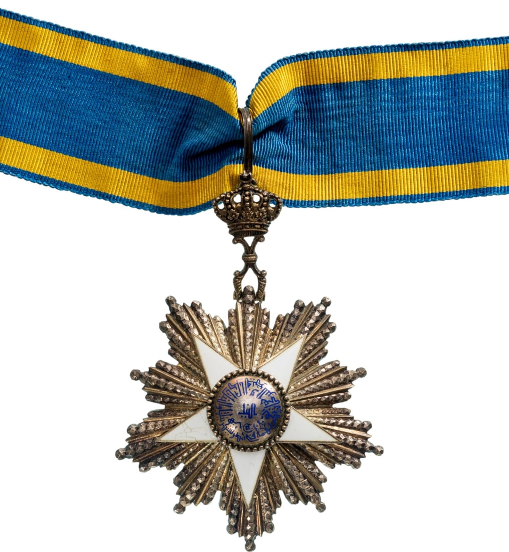 ORDER OF THE NILE: Commander's Cross, 3rd Class. Neck Badge, 92x64 mm., Silver, maker's mark "Lattes", one side enameled, central medallion gilt, enameled, original gilt suspension crown, loop and ribbon. Extremely fine