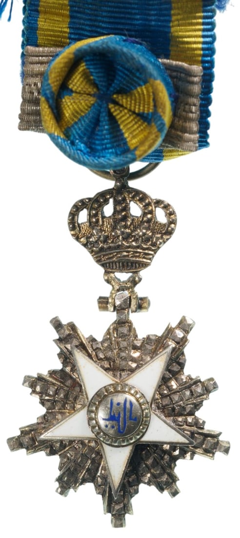 ORDER OF THE NILE: Commander's Cross Miniature, instituted in 1915. Breast Badge, 30x19 mm, Silver, center gilt, one side enameled, with diamond cut rays, original crown suspension device, loop and original ribbon with 