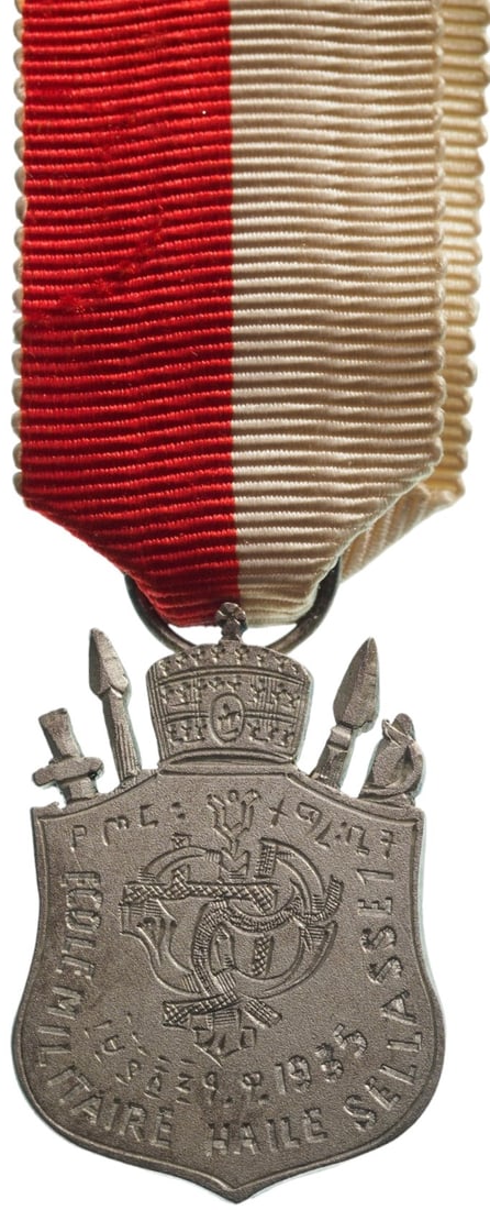 Haile Selassie I Military College Jubilee Medal, instituted in 1960.: Breast Badge Miniature, 20x15 mm, white Metal, original suspenion ring and ribbon. I