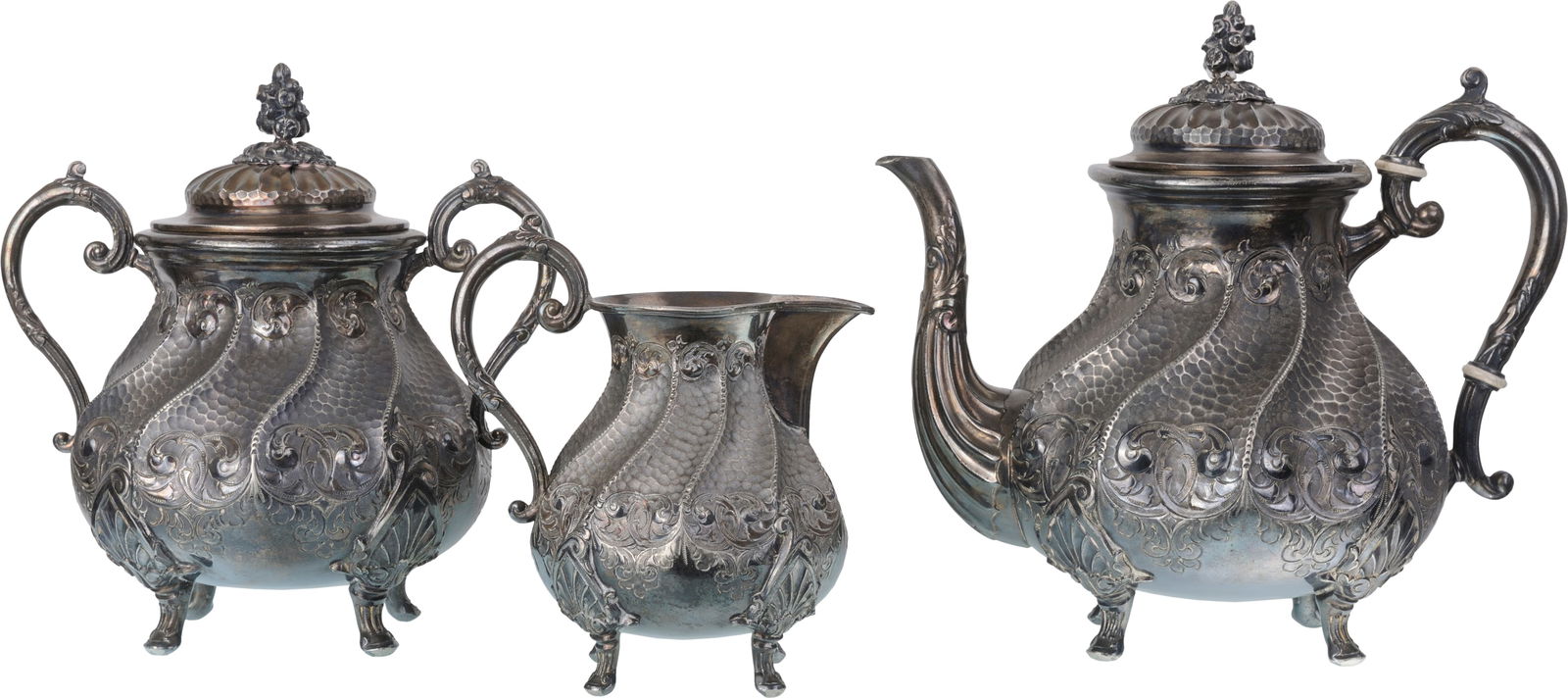 Three-piece set consisting of a large coffee maker, a covered sugar bowl and a milk jug: Three-piece set consisting of a large coffee maker, a covered sugar bowl and a milk jug. Low-grade silver and amalgam tin and copper, beautiful homogeneous pattern with twisted ribs on a "bat" wings b