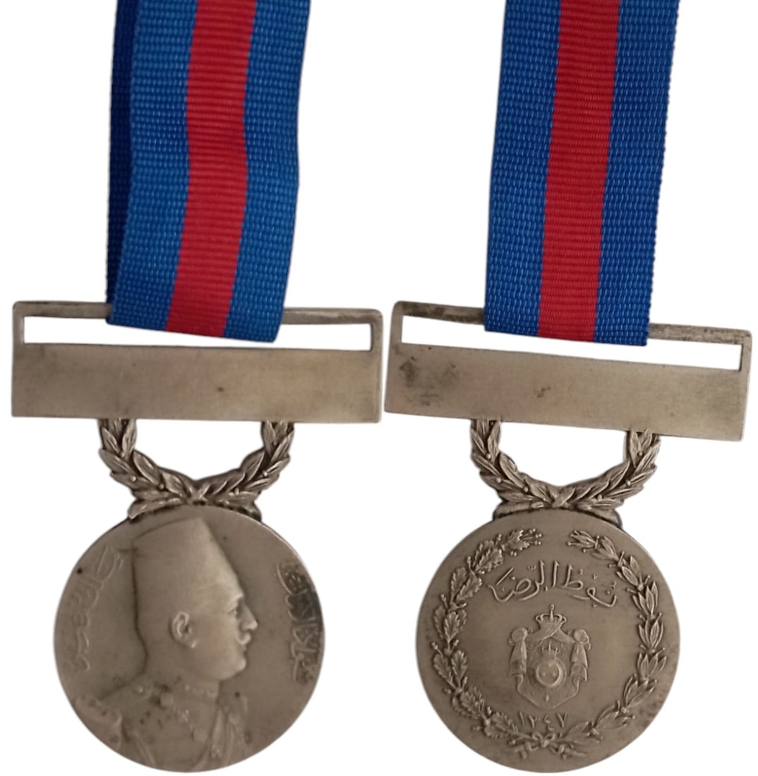 Medal of Benevolence, King Fuad Issue (1928-36), Type 1, 2nd Class Medal, 1928: Breast Badge, 52x36 mm, Silver, original suspension ring and thin ribbon. Extremely fine and scarce! I