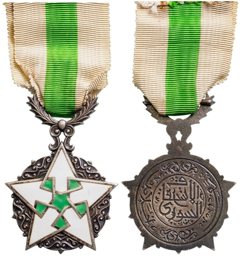 ORDER OF CIVIL MERIT: Knight's Cross, instituted in 1926. Breast Badge, 61x44 mm, Silver, one-side enameled, five-pointed, white and green enameled star of elaborate geometric design, with decorative designs between the st