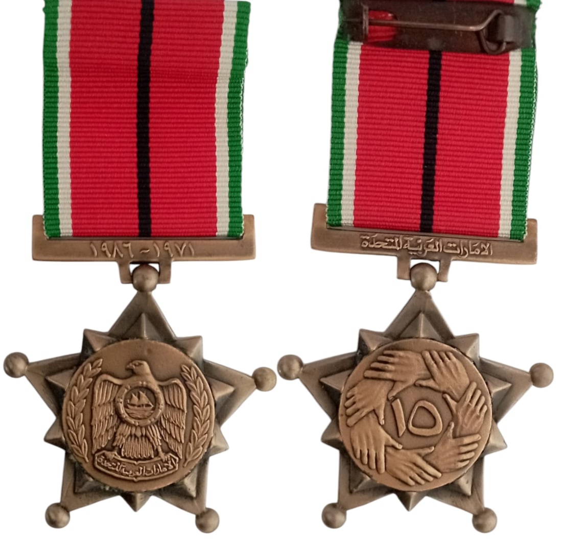 15th National Day Medal, 1986: Breast Badge, 50x45 mm, Bronze, original suspension ring and ribbon with suspension clasp. Mint state and scarceI I R!