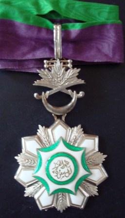 ORDER OF KING ABDUL AZIZ: Country: SAUDI ARABIA Commander's cross. Neck badge one side enameled central medallion enameled with ornamented suspension device and original ribbon very fine!