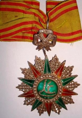 ORDER OF NICHAN EL IFTIKAR: Country: TUNISIA Commander's Cross. Neck Badge silver brilliant cut rays enameled original suspension device and original loop with ribbon.