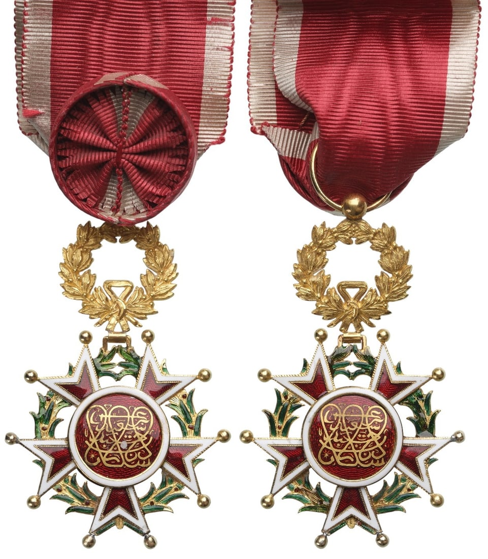 Order of the Brilliant Star of Zanzibar: Officer's Cross, instituted in 1963. Breast Badge, 67x42 mm., GOLD, approx. 17 g., enameled, original suspension wreath and ribbon with rosette. A splendid and extremely rare badge in gold, of the hig