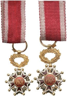Order of the Brilliant Star of Zanzibar: Officer's Cross Miniature, instituted in 1963. Breast Badge, 19x12 mm., GOLD, 1.5 g., enameled, original suspension wreath and ribbon. A beautiful, very rare miniature, in extremely fine condition! I 